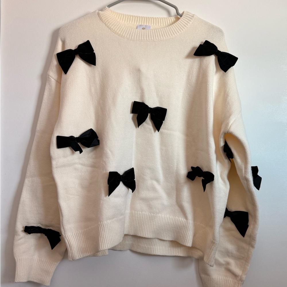 Elegant Cream Sweater with Black Bow Accents